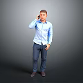 A Man Talking on the Phone in Blue Shirt and Dark Pants Against Gray Background