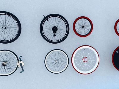 Assorted Bicycle Tires with Black Red White Rims Arranged on White Background 3d model
