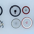 Assorted Bicycle Tires with Black Red White Rims Arranged on White Background