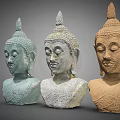 Three Buddha Head Sculptures Intricately Carved With Varied Colors And Classic Features