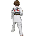 Man in White Taekwondo Uniform With Yellow Belt Standing in Martial Arts Pose