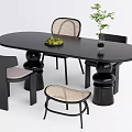 Modern Black Oval Dining Table Set With Woven Chairs Stool Fruit Bowl And Potted Plant