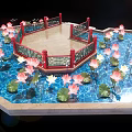 Octagonal Red Railed Platform Surrounded By Pool With Pink White Lotus Flowers And Green Leaves