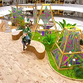 Open Multi Level Indoor Public Space With Colorful Geometric Structures Green Plants And Wooden Flooring