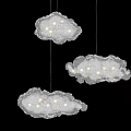 Delicate Cloud Shaped Chandeliers With Lace Design And White Lights Hanging In Dark Background