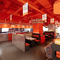 Huopan Restaurant Featuring Grilled Lamb Skewers With Vibrant Orange Decor And Cozy Seating Area