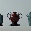 Ceramic Vessels In Turquoise And Red With Decorative Handles And Textured Surfaces