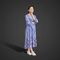 A Woman Standing in Blue Purple Printed Dress with Crossed Arms and White Shoes