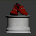 Red Loafers with Metallic Accents Displayed on White Pedestal with Wooden Top