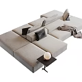 Modern Light Gray Sectional Sofa with Black Cushions Throw Blanket and Side Table Lamp