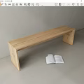 Sleek Light Wooden Bench With Open Book In Minimalist Interior Design