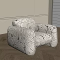 Modern Single Sofa With Abstract Black And White Pattern Rounded Armrests And Wooden Floor