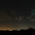 Colorful Light Dot Circles In Night Sky With Horizon City Lights