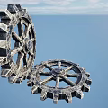 Large Metallic Gears in Industrial Equipment with Blue Sky and Ocean Background