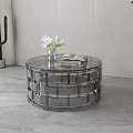 Clear Acrylic Round Coffee Table With White Flowers Vase And Open Book In Modern Minimalist Space