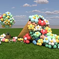 Colorful Inflatable Structures In Various Shapes On Green Grass Field With Cloudy Sky
