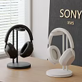 Sony XM5 Headphones Black And White On Stands Table