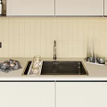 Stainless Steel Kitchen Sink with Brushed Faucet in Modern Kitchen on Beige Countertop and Glassware