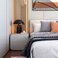 Double Bed with White Gray Orange Pillows Black Lamp on Nightstand and Decorative Wall Art