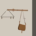 Wooden Hook Rack With Metal Hooks And Brown Bag Hanging On Wall