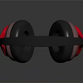 Modern Headphones with Black Headband and Red Black Ear Cups on Black Reflective Surface
