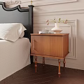 Brown Wooden Nightstand With Gold Handle Cabinet Door And White Vase With Flowers