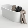Elegant Modern White Bathtub With White Gray And Beige Towels Hanging