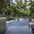 Modern Garden Landscape with Lush Trees Playground Pathway and Seating Benches