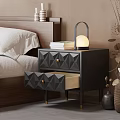 Modern Black Nightstand With Diamond Shaped Drawers Lamp And Stack Of Books