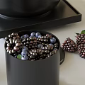 Modern Black Tea Set with Teapot Lidded Containers and Fresh Blackberries on Tray