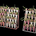 Floral Display with Multi Tiered Stands Pink White Patterned Pots and Green Foliage