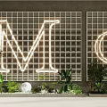 Glass Block Grid Wall With Neon Letter M G Green Plants And White Decorative Sphere
