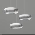 Three White Oval Pendant Lights With Paper Shades Hanging On Gray Wall