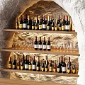 Natural Stone Bar Counter Interior With Layered Shelves Displaying Wine Bottles