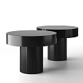 Modern Black Round Coffee Tables With Ribbed Cylindrical Bases And Sleek Surface Design
