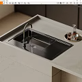 Black Kitchen Sink With Silver Faucet And Flowing Water On Light Colored Countertop