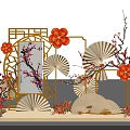 Traditional Chinese Decorative Setup With Plum Blossoms Red Flowers Folding Fans And Carved Lattice