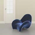 Blue Velvet Accent Chair With Modern Curved Design In Bright Light Room