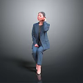 Cute Child in Navy Blue Suit and Grey Top Sitting on Dark Background Touching Ear
