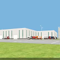 Industrial Factory Building with White Exterior Green Stripes Front Parking Lot Trucks and Street Lamps