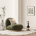 Green Single Sofa With Throw Pillow And Side Table Near Plant And Wall Art