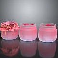 Artisan Sculpted Glass Jars With Pink Liquid And Checkered Lids On Dark Background