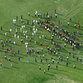 Aerial View of Many People Gathered Together Outdoor on Green Grass Field