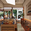 Dessert Shop Display Case Fresh Bread Pastries Wooden Elements Bright Lighting Window Seats Street View