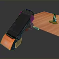 Black And Orange Computer Stand On Wooden Desktop With Small Black Holder