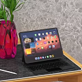 Tablet With Keyboard On Wooden Table Near Red Vase Green Plant And Stylus Pen