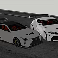 Gray And White High Performance Sports Cars With Sporty Design And Rear Spoilers On Road