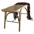 Light Wooden Footstool With Curved Frame Wicker Top And Draped Plaid Blanket