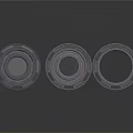 Three Black Circular Mechanical Components With Central Holes And Raised Edges