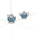 Two Stylish Blue Metallic Teapots With Silver Bases And Elegant Design
